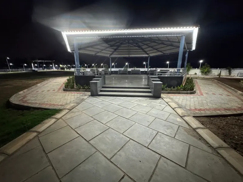 The pavilion outlined in lights at night